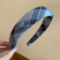 Detail of grey plaid thick headband showing Korea button and Handmade textile label - Black & Grey Plaid