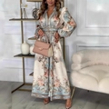 Detailed view of elegant floral maxi dress featuring waist tie and button-up puff sleeves - S / Apricot