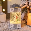 Beleuchtete Weihnachtsgeschenkbox Schneekugel mit Schneemann und Schleife - Telefonierender Schneemann / Weiß