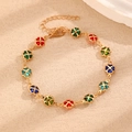 Golden chain bracelet with colorful enamel four-leaf clovers in red, green, and blue - KC Gold Four Leaf Clover Bracelet