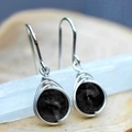 Handcrafted silver wire-wrapped earrings featuring round black natural stones - Black