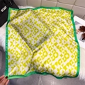 Detailed view of green and yellow silk square scarf with geometric circular patterns - Yellow-Green