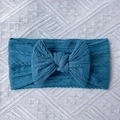 Peacock blue knitted baby headband featuring a large bow and soft cable stitch pattern - Navy Blue