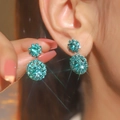 Elegant silver snowflake earring with tiffany blue rhinestones shown on model - Tiffany Blue