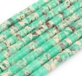 Macro detail of disc-shaped green emperor pine stone spacer beads for jewelry making - Translucent Green Texture