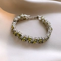 Elegant silver bracelet featuring marquise-cut olive green zircons on champagne satin - Green