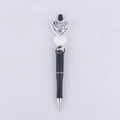 Close-up of DIY beaded pen with white heart topper featuring baking terms like sugar and milk - Cocoa