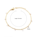 Detail of golden charm bracelet featuring teardrop crystals and lobster clasp closure - Gold Hanging Zircon Teardrop Bracelet