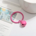 Matte pink bell pendant keychain accessory on newspaper background for DIY bags - Rose Red