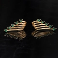 Detailed close-up of gold angel wing ear cuffs with green heart-shaped gemstones - Green