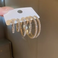 Three pairs of gold hoop earrings in small, medium, and large sizes with shiny rhinestones - Gold Style (5604402HB)