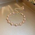 Detailed macro view of the vintage pearl bracelet with adjustable sliding gold clasp - Champagne Pearl Bracelet