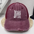 Distressed vintage burgundy trucker hat featuring Jesus Saved My Life print and mesh back - Burgundy