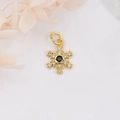 Macro shot of 18k gold plated snowflake pendant with black and clear zircon crystals - Gold with Black Zircon