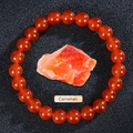 Natural orange red carnelian beaded bracelet with raw crystal stone on black background - Red Agate