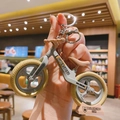Detailed macro shot of a mini balancing bike keychain with Super Speed text and logo - Light Green
