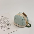 Detailed view of mint green quilted heart pattern AirPods pouch with pearl charm zipper - Green