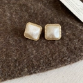 Detail of square gold plated earrings with white mother-of-pearl on brown felt - Gold Square (Gold Plated Silver Pin)