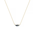 Detail of gold chain necklace featuring a clustered deep blue gemstone pendant - December / Blue Zirconia