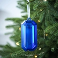 Blue faceted gem Christmas tree ornament with 13cm height shown in a festive setting - Blue