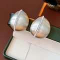 Macro shot of silver drop earrings with matte finish and pearls in a green gift box - Silver (Silver Pin)