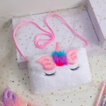 Detail of white plush unicorn bag featuring pink sequin wings and embroidered eyelashes - White