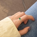 Detail of vintage irregular silver ring with oval green zircon worn on finger - Adjustable Open / Silver/Green Zirconia