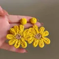 Detailed view of handmade yellow woven flower earrings with brown cord centers - 10# Steel Needle-Yellow (Sunflower Woven)