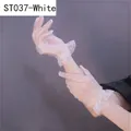 Detail of white bridal lace gloves featuring mesh texture and ruffled cuffs in a side view - White Lace Grid Ruffles (ST037)