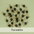 Dark green faceted gemstone beads with gold metal wire findings on a light green background - Green Sandstone Style (07S) / 50 Pieces / Green