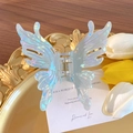 Iridescent butterfly hair claw clip in translucent blue on a decorative gold tray - Iridescent Green