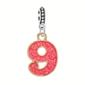 Detail of a golden alloy number 9 pendant with pink floral enamel for DIY bracelets - Number-9