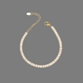 Detailed close-up of golden square zircon bracelet with lobster clasp and adjustable chain - Gold