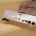 Set di 5 paia di orecchini dorati con perle, cuori neri e design con fiocchi - Perno in argento 925 / Oro (Set di 10)