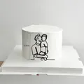Detail showing 11.5cm minimalist acrylic cake topper with father and son line art - Father and Son Hugging / Black