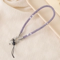 Detailed view of luxury purple rhinestone wrist strap for phone and keys with silver clasp - Purple