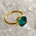 Macro shot of gold stainless steel ring with emerald green square cubic zirconia gemstone - Gold Base: Dec-Cyan Blue