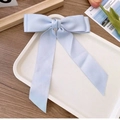 Elegant oversized light blue satin butterfly hair clip with long ribbons on white tray - Sky Blue