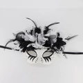 Detail of Day of the Dead mask featuring intricate black feathers, lace, and floral accents - 2025 Dark Painted Day of the Dead