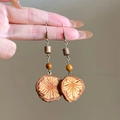 Detailed close-up of ethnic fish-shaped earrings with red natural wood textures - Style 13 Ear Hook