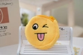 Close-up of yellow plush cartoon coin purse with emoji embroidery on a mini wooden bench - Style 10 (Wink Tongue 2)