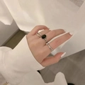 Minimalist silver chain rings with black oval stone on female model hands - Silver Black Oval Stone Rings