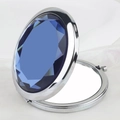 Portable folding metal makeup mirror with a large oval blue gemstone in silver finish - Diamond Round Mirror Silver Frame Dark Blue Gem
