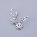 Macro shot of S925 sterling silver hoop earrings with hollow smiley face pendants - Smile Face - Silver