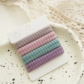 Detailed view of five pastel ribbed hair ties on a display card over a lace background - Ribbed Fabric / Pink Purple (4 Pcs/Card)