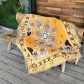 Macro view of bohemian woven blanket featuring yellow paisley patterns and decorative tassels - Mustard Yellow Mandala / 130x160cm
