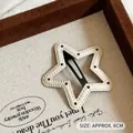 Star-shaped white PU leather hair clip with black stitching and internal metal BB grip - White Star Black Polka Dot