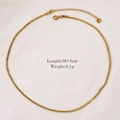 Detail view of 14k gold plated snake chain necklace with lobster clasp on white fabric - Gold Snake Bone Chain Necklace
