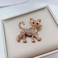 Golden cat brooch with sparkling white crystals and black gemstone eyes in walking pose - Gold Rhinestone Cat (136)