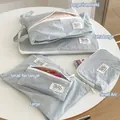 Set de bolsas de viaje de nailon azul claro impermeable en varios tamaños para ropa - Curvo Pequeño / Azul